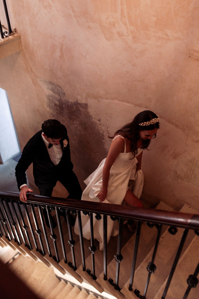 Anna and Tom ascending the grand staircase, showcasing the venue’s elegant architecture.