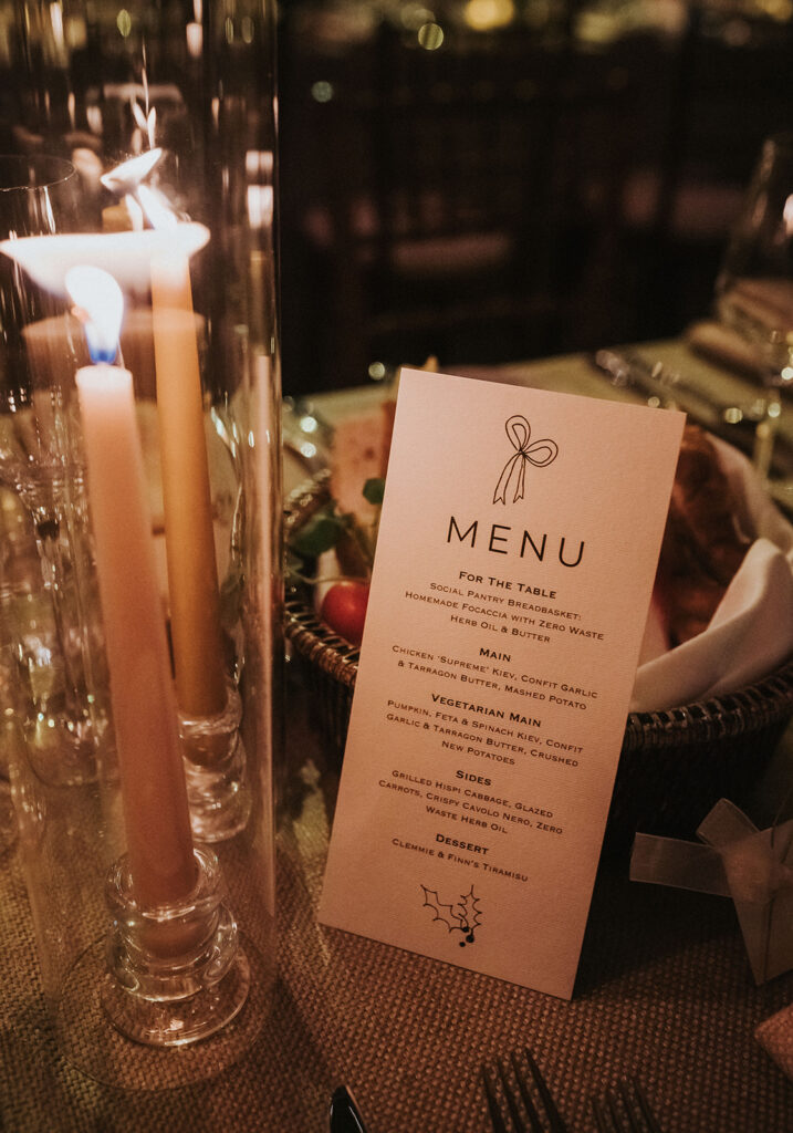 A close-up of the elegant wedding menu designed by Maple and Ray, showcasing a bespoke selection of courses, placed on the table.