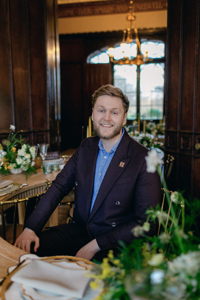 James Green of Events by James reviewing a detailed wedding timeline in a stylish workspace.