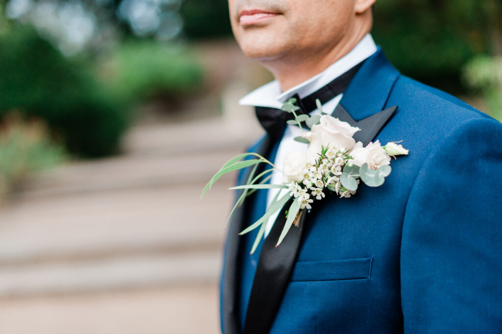 Groom with a boutonniere standing in the gardens of The Orangery Holland Park, exemplifying the venue’s charm during Weddings at the Orangery Holland Park.