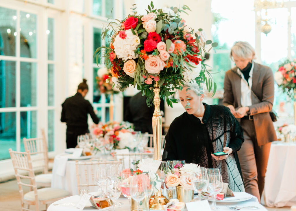 Elegant dining setting featuring crystal glassware, fine china, and lush floral arrangements.