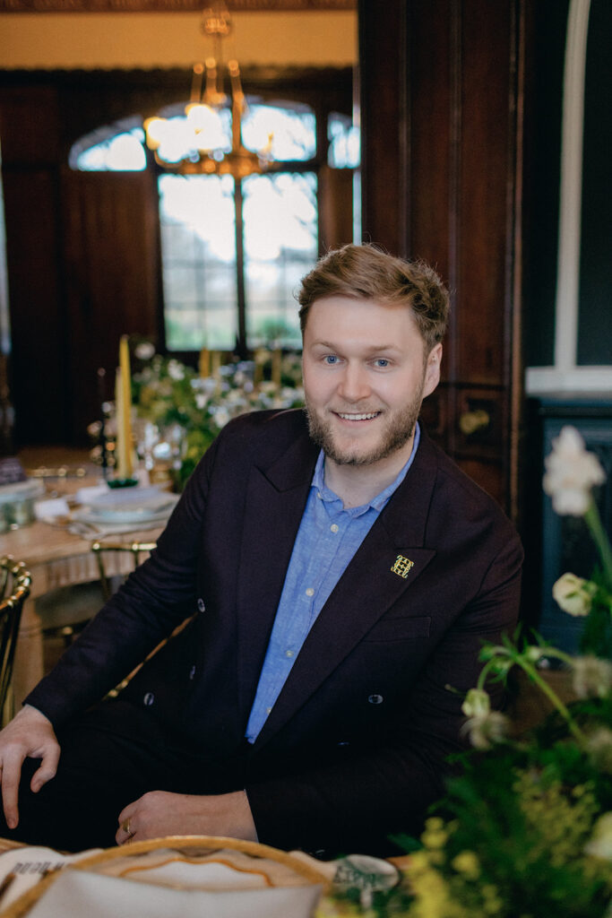 James Green of Events by James, captured in a thoughtful moment during an elegant event setup.