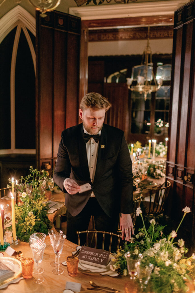 James Green arranging name cards on a beautifully styled table, ensuring every detail is perfect.