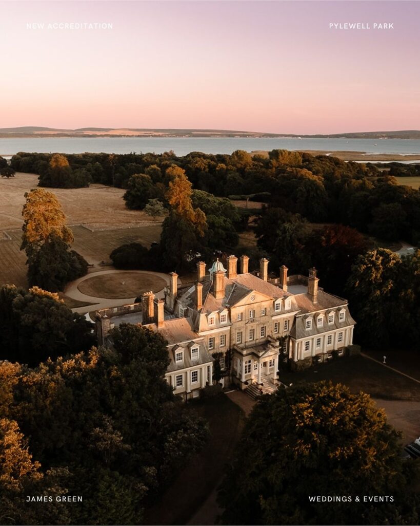 Aerial view of Pylewell Park wedding venue at sunset, showcasing the stately home surrounded by golden trees and overlooking the sea.