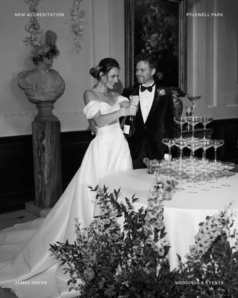 Newlyweds popping champagne in the elegant interior of Pylewell Park during a black-tie wedding celebration with a champagne tower.