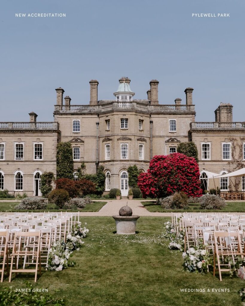 Outdoor wedding ceremony setup in front of Pylewell Park’s grand façade, with florals lining the aisle and a backdrop of the historic house.